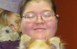 A woman holding a dog in her arms.